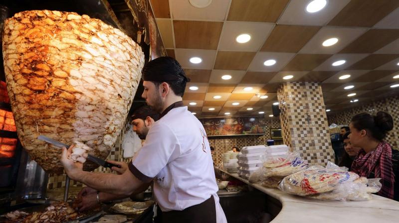 Shawarma is typically cooked outdoors, with spiced chicken (Photo: AFP) Shawarma is typically cooked outdoors, with spiced chicken (Photo: AFP)