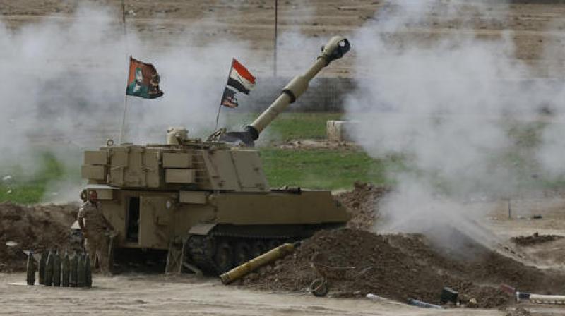 Iraqi soldiers fire a shell from a tank in the Iraqi village of Ali Rash toward Mosul in the fight against Islamic State militants. (Photo: AP) Iraqi soldiers fire a shell from a tank in the Iraqi village of Ali Rash toward Mosul in the fight against Islamic State militants. (Photo: AP)