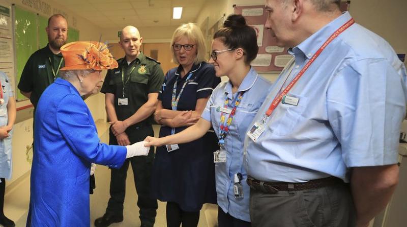 Britain’s Queen Elizabeth II speaks with hospital personnel as she visits the Royal Manchester Children’s Hospital to meet victims of the terror attack in the city earlier this week and to thank members of staff who treated them (Photo: AP) Britain’s Queen Elizabeth II speaks with hospital personnel as she visits the Royal Manchester Children’s Hospital to meet victims of the terror attack in the city earlier this week and to thank members of staff who treated them (Photo: AP)