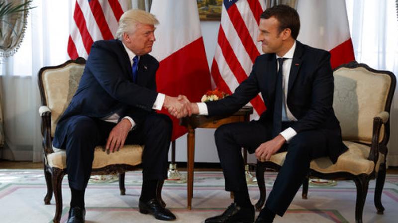 Donald Trump, Emmanuel Macron President Donald Trump shakes hands with French President Emmanuel Macron during a meeting at the U.S. Embassy, Thursday (Photo: AP) Donald Trump, Emmanuel Macron President Donald Trump shakes hands with French President Emmanuel Macron during a meeting at the U.S. Embassy, Thursday (Photo: AP)