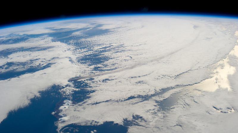 A trail of smoke can be seen from the 2013 eruption of the Pavlof volcano, which spewed an ash cloud 20,000 feet into the atmosphere that traveled southeastward over the North Pacific Ocean. The volcanos that may have contributed to snowball Earth spanned almost 2000 miles and erupted continuously for years. (Image courtesy of NASA) A trail of smoke can be seen from the 2013 eruption of the Pavlof volcano, which spewed an ash cloud 20,000 feet into the atmosphere that traveled southeastward over the North Pacific Ocean. The volcanos that may have contributed to snowball Earth spanned almost 2000 miles and erupted continuously for years. (Image courtesy of NASA)