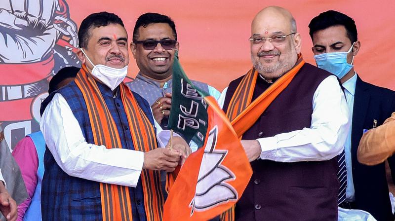 Union Home Minister Amit Shah (R) with Subhendu Adhikary (2L), former TMC leader who joined BJP, during an election rally ahead of West Bengal Assembly polls 2021, in West Midnapore district, Saturday, Dec. 19, 2020. (PTI)