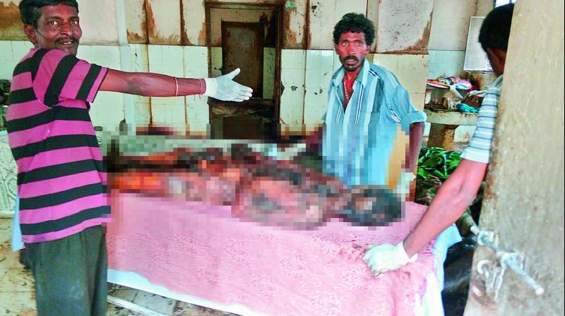 GHMC staff workers and forensic science workers clean up the highly decomposed bodies that were dumped in the Osmania General Hospital without the luxury of having face masks to ward off the stench. GHMC staff workers and forensic science workers clean up the highly decomposed bodies that were dumped in the Osmania General Hospital without the luxury of having face masks to ward off the stench.