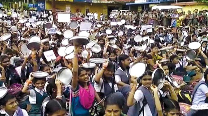 A file photo of students and staff of schools run by RSS strongman Kalladka Prabhakar Bhat protesting when the previous Congress government stopped the benefits of the meal scheme to the schools. A file photo of students and staff of schools run by RSS strongman Kalladka Prabhakar Bhat protesting when the previous Congress government stopped the benefits of the meal scheme to the schools.