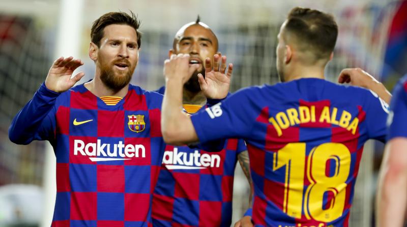 Barcelonas Jordi Alba, right, celebrates with Barcelonas Lionel Messi (AP)