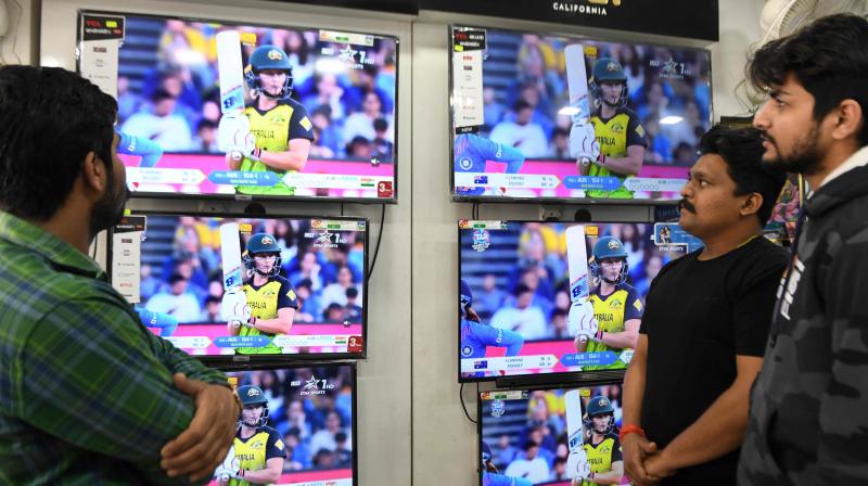 Cricket fans watch the live broadcast of the womens World Cup cricket final Twenty20 match  between Australia and India in an electronics shop (AFP)