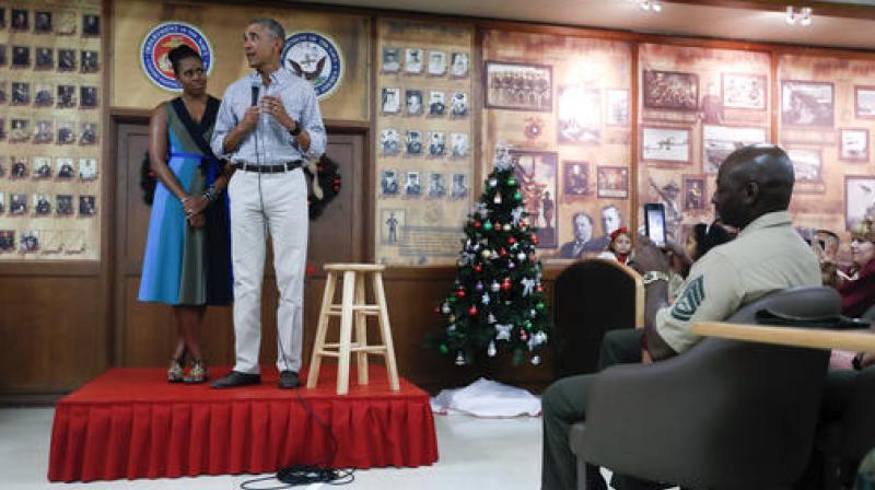 President Barack Obama, joined by first lady Michelle Obama, speaks during an event to thank service members and their families at Marine Corps Base Hawaii, in Kaneohe Bay, Hawaii. (Photo: AP) President Barack Obama, joined by first lady Michelle Obama, speaks during an event to thank service members and their families at Marine Corps Base Hawaii, in Kaneohe Bay, Hawaii. (Photo: AP)