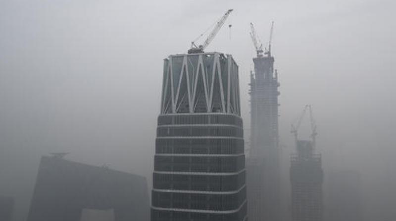 China's state broadcaster China Central Television (CCTV) headquarters and construction buildings at the Central Business District are shrouded by heavy smog in Beijing. (Photo: AP) China's state broadcaster China Central Television (CCTV) headquarters and construction buildings at the Central Business District are shrouded by heavy smog in Beijing. (Photo: AP)