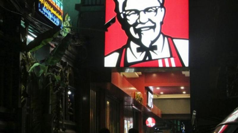A sign of KFC’s grinning Colonel Sanders and his goatee is lit outside its outlet in Yangon, Myanmar. (Photo: AP) A sign of KFC’s grinning Colonel Sanders and his goatee is lit outside its outlet in Yangon, Myanmar. (Photo: AP)