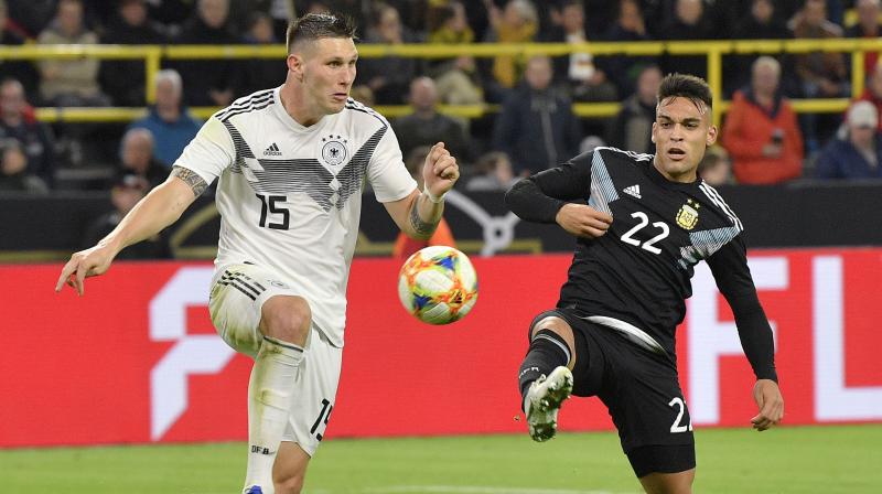 Injury-decimated Germany squandered a two-goal lead to draw 2-2 with Argentina thanks to Lucas Ocampos’s 85th-minute equaliser in a friendly on Wednesday. (Photo: AP) Injury-decimated Germany squandered a two-goal lead to draw 2-2 with Argentina thanks to Lucas Ocampos’s 85th-minute equaliser in a friendly on Wednesday. (Photo: AP)