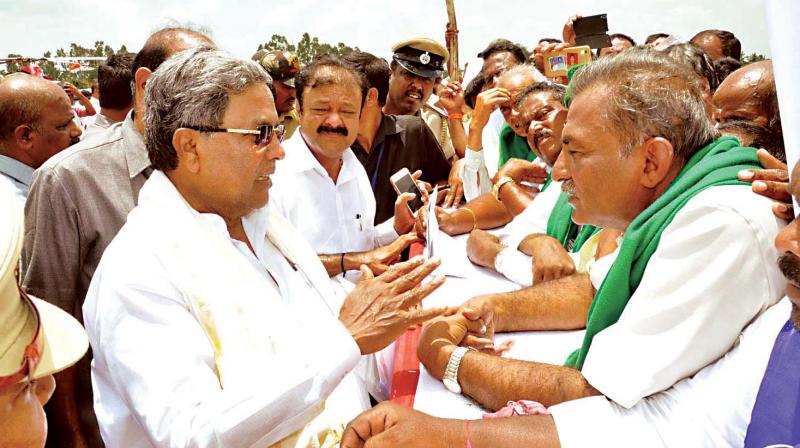Chief Minister Siddaramaiah interacts with farmers during his visit to Mandya to launch various developmental works on Friday Chief Minister Siddaramaiah interacts with farmers during his visit to Mandya to launch various developmental works on Friday