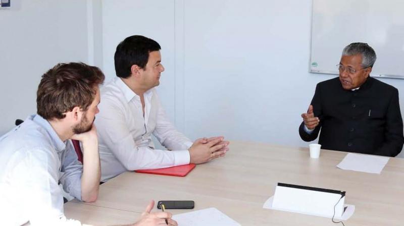 Chief Minister Pinarayi Vijayan discusses a point with noted French economist Thomas Piketty and Lucas Chancel, professor at Paris School of Economics, in Paris on Thursday. Chief Minister Pinarayi Vijayan discusses a point with noted French economist Thomas Piketty and Lucas Chancel, professor at Paris School of Economics, in Paris on Thursday.