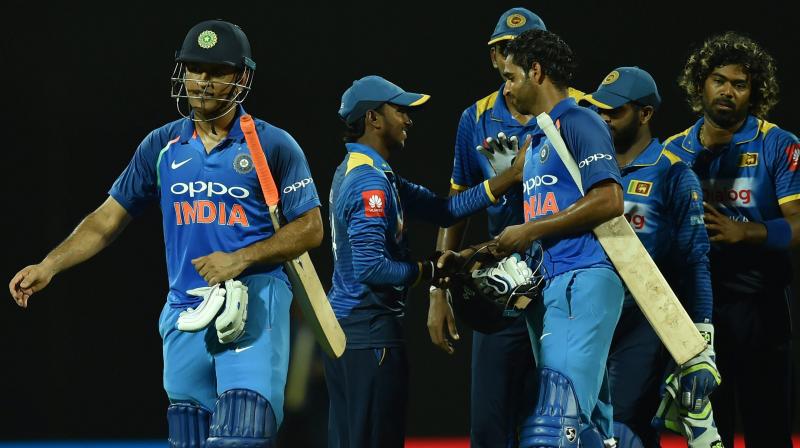 Srilanka's Akila Dananjaya greets India's Bhuvneshwar Kumar as India's MS Dhoni walks after win the match against Srilanka during the second ODI match at Pallekele International Cricket Stadium at Pallekele, Kandy in Sri Lanka, on Thursday. (Photo: AP) Srilanka's Akila Dananjaya greets India's Bhuvneshwar Kumar as India's MS Dhoni walks after win the match against Srilanka during the second ODI match at Pallekele International Cricket Stadium at Pallekele, Kandy in Sri Lanka, on Thursday. (Photo: AP)
