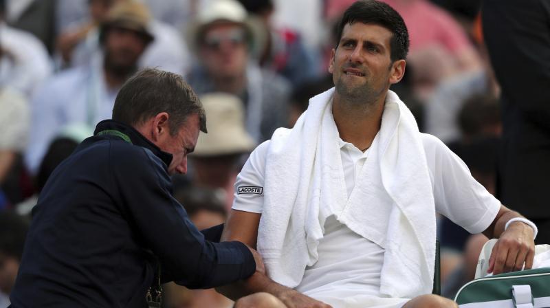 Novak Djokovic receives medical treatment during his Men's Singles Match against Czech Republic's Tomas Berdych on day nine of the Wimbledon Tennis Championships. (Photo: AP) Novak Djokovic receives medical treatment during his Men's Singles Match against Czech Republic's Tomas Berdych on day nine of the Wimbledon Tennis Championships. (Photo: AP)