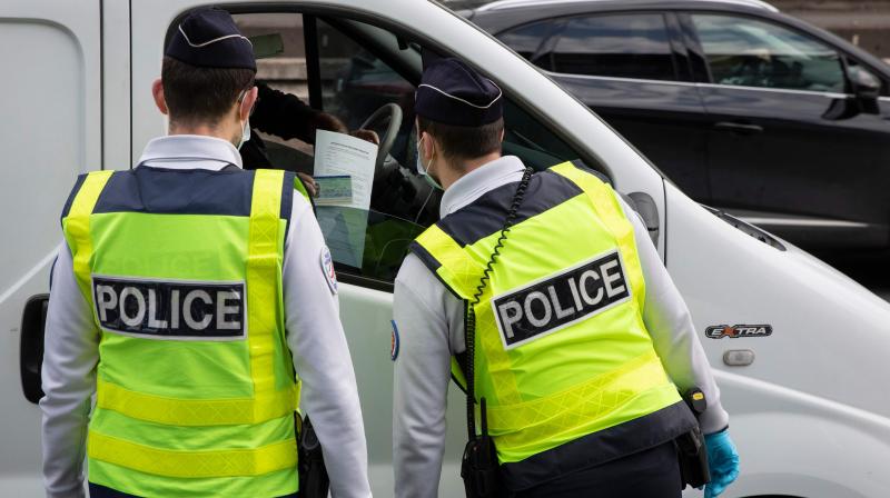 French police check motorists outings authorisation on Paris ring-road on Saturday. (AFP)