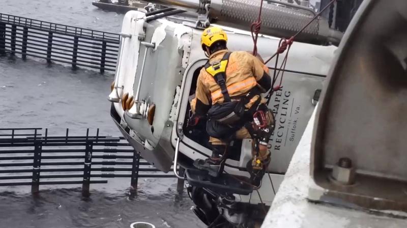 Chesapeake firefighter Justin Beazley, a member of the technical rescue team, rappels off the side of the I-64 Highrise Bridge to rescue the driver of a tractor-trailer that jackknifed, hanging 70 feet over the Elizabeth River. Picture courtesy: Chesapeake Fire Department