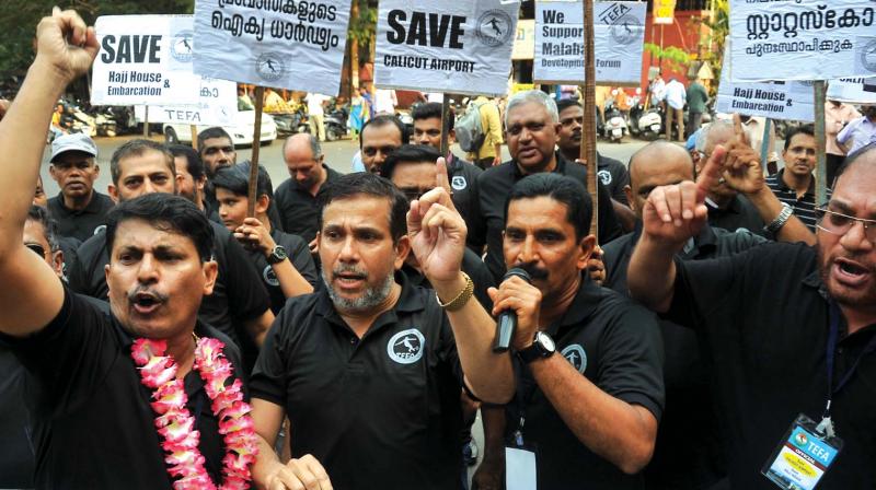 Men shout slogans marking the end of a ‘day and night' agitation demanding reinstating the embarkation status to Calicut airport in Kozhikode on Saturday. (Photo: DC) Men shout slogans marking the end of a ‘day and night' agitation demanding reinstating the embarkation status to Calicut airport in Kozhikode on Saturday. (Photo: DC)