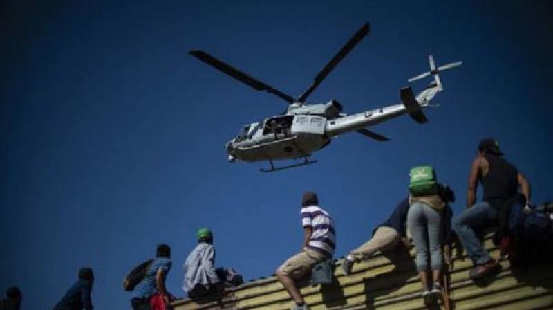 Video clips posted on Twitter showed large numbers of migrants dashing across a shallow concrete waterway toward the border (Photo: AFP) Video clips posted on Twitter showed large numbers of migrants dashing across a shallow concrete waterway toward the border (Photo: AFP)