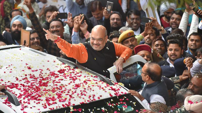 BJP President Amit Shah gestures while being welcomed on his arrival at the party headquarters in New Delhi on Monday, after the party's victory in the Assembly elections in Gujarat and Himachal Pradesh. (Photo: PTI) BJP President Amit Shah gestures while being welcomed on his arrival at the party headquarters in New Delhi on Monday, after the party's victory in the Assembly elections in Gujarat and Himachal Pradesh. (Photo: PTI)