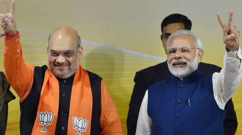 Prime Minister Narendra Modi and BJP President Amit Shah flash victory sign at a felicitation function before the party's parliamentary board meeting in New Delhi on Monday, after the party's win in Gujarat and Himachal Pradesh Assembly elections. (Photo: PTI) Prime Minister Narendra Modi and BJP President Amit Shah flash victory sign at a felicitation function before the party's parliamentary board meeting in New Delhi on Monday, after the party's win in Gujarat and Himachal Pradesh Assembly elections. (Photo: PTI)