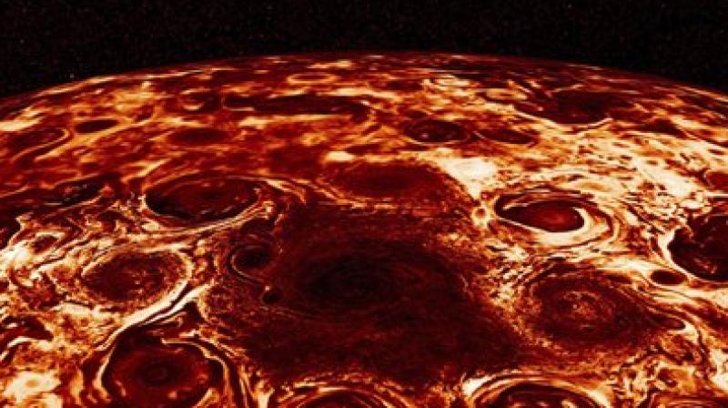 This composite image provided by NASA, derived from data collected by the Jupiter-orbiting Juno spacecraft, shows the central cyclone at the planet’s north pole and the eight cyclones that encircle it. (NASA/JPL-Caltech/SwRI/ASI/INAF/JIRAM via AP) This composite image provided by NASA, derived from data collected by the Jupiter-orbiting Juno spacecraft, shows the central cyclone at the planet’s north pole and the eight cyclones that encircle it. (NASA/JPL-Caltech/SwRI/ASI/INAF/JIRAM via AP)