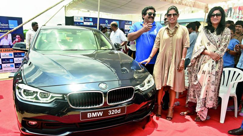 Mithali (right) is all smiles as she poses with her new BMW car alongside Chamundeshwaranath (who gifted her the car) in a presentation event at the Pullela Gopichand Badminton Academy in Hyderabad on Tuesday. (Photo: R. Pavan) Mithali (right) is all smiles as she poses with her new BMW car alongside Chamundeshwaranath (who gifted her the car) in a presentation event at the Pullela Gopichand Badminton Academy in Hyderabad on Tuesday. (Photo: R. Pavan)