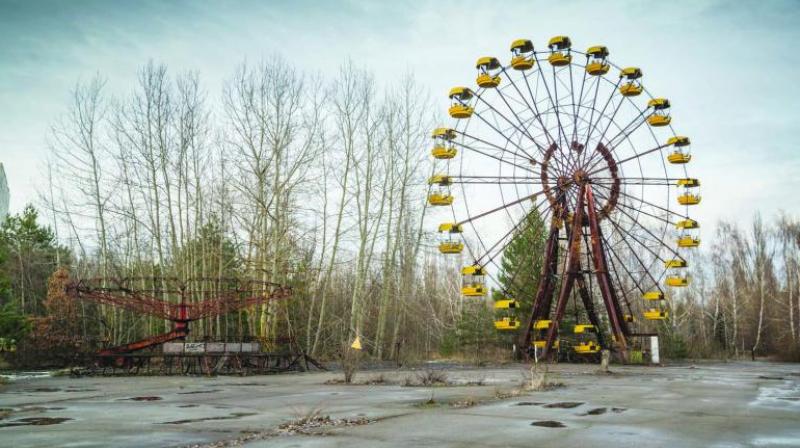 The image of an abandoned giant wheel in the premises of Chernobyl Nuclear Power Plant. The image of an abandoned giant wheel in the premises of Chernobyl Nuclear Power Plant.