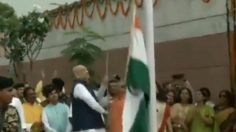 The Congress posted a video on its official Twitter handle in which the BJP chief is seen unfurling the flag, which falls down soon after he pulls the string. (Photo: Screengrab) The Congress posted a video on its official Twitter handle in which the BJP chief is seen unfurling the flag, which falls down soon after he pulls the string. (Photo: Screengrab)