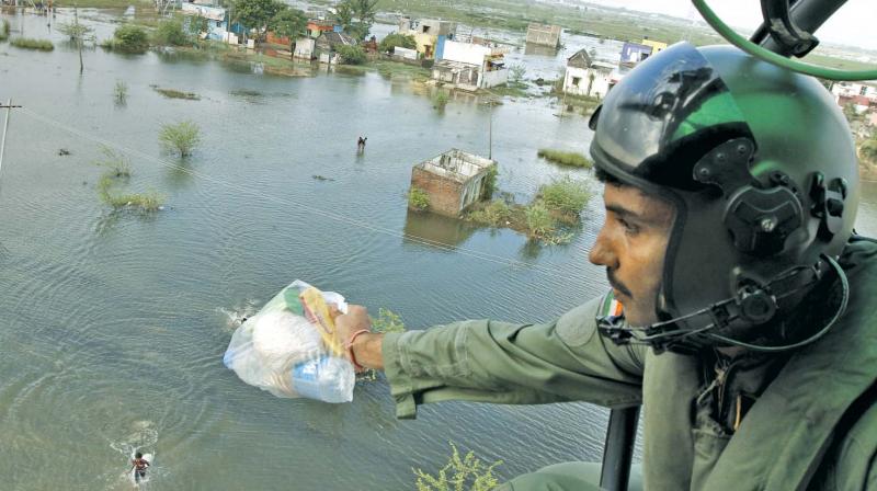 An Indian Air Force personnel distributes relief material during last year's deluge in the city (Photo: DC) An Indian Air Force personnel distributes relief material during last year's deluge in the city (Photo: DC)