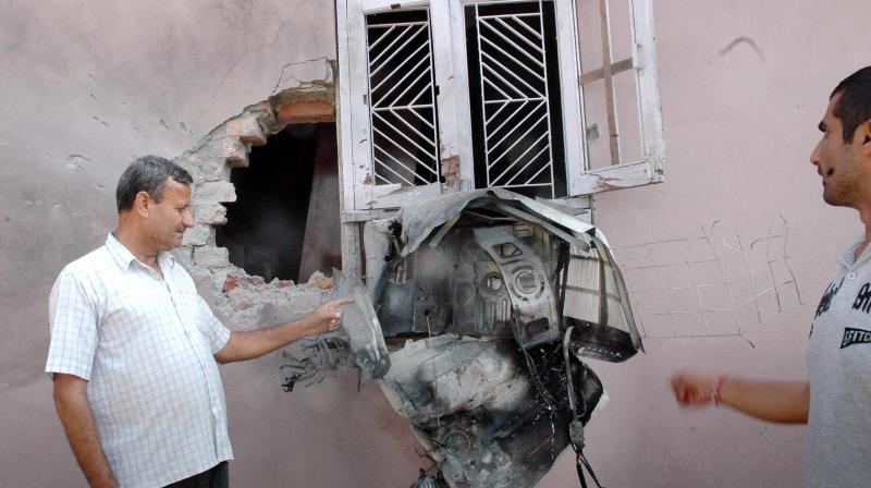 A villager shows a house damaged due to alleged shelling from across the LoC in Gajansoo Marh village, Jammu (Photo: PTI) A villager shows a house damaged due to alleged shelling from across the LoC in Gajansoo Marh village, Jammu (Photo: PTI)