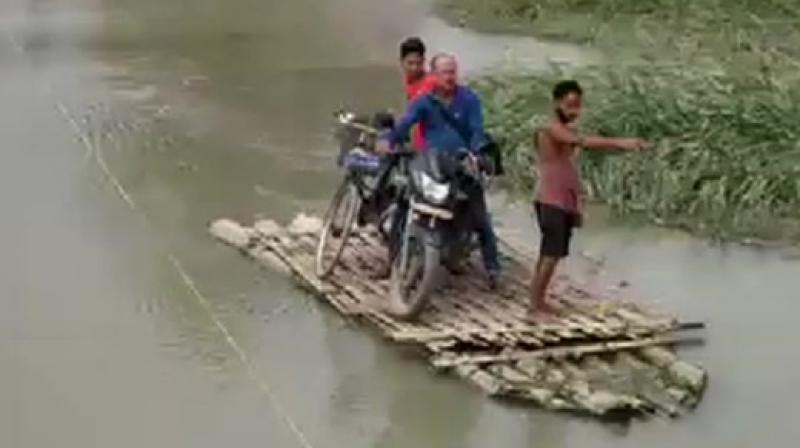 As heavy rainfall in Bhutan leads to rise in water levels of Pagladia and Borolia rivers washing away a bridge in Tamulpur & obstructing Tamulpur's connection to Baksa District Headquarters. (Photo: ANI) As heavy rainfall in Bhutan leads to rise in water levels of Pagladia and Borolia rivers washing away a bridge in Tamulpur & obstructing Tamulpur's connection to Baksa District Headquarters. (Photo: ANI)