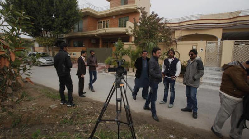 Pakistani journalists and local residents gather out the home of Salman Haider. (Photo: AP) Pakistani journalists and local residents gather out the home of Salman Haider. (Photo: AP)