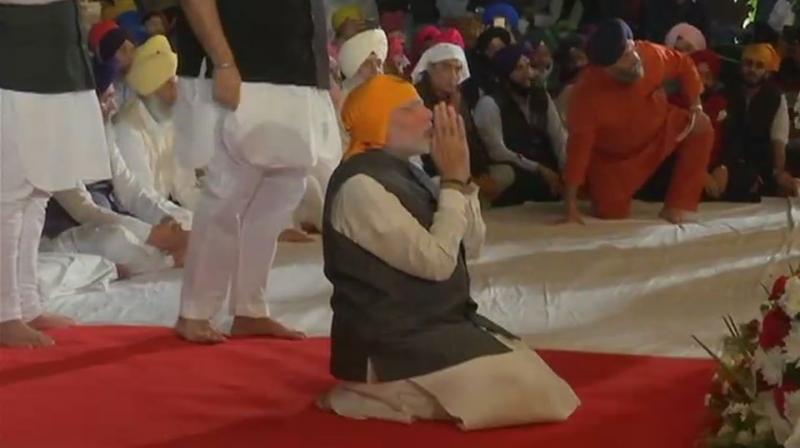 The Prime Minister offered 'ardaas' (prayers) to Guru Granth Sahib, the holy book of the Sikhs and sat to listen to gurbani during his visit. (Photo: ANI) The Prime Minister offered 'ardaas' (prayers) to Guru Granth Sahib, the holy book of the Sikhs and sat to listen to gurbani during his visit. (Photo: ANI)