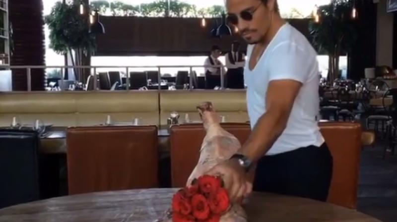 Turkish chef Nusret Gökçe or ‘Salt Bae’ is seen removing a rose bouquet out of the rear end of a healdless calf. (Photo: Instagram) Turkish chef Nusret Gökçe or ‘Salt Bae’ is seen removing a rose bouquet out of the rear end of a healdless calf. (Photo: Instagram)