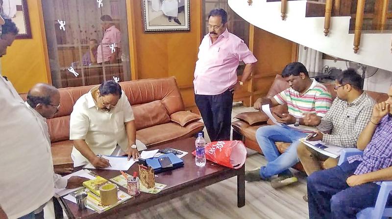DMK treasurer Durai Murugan examining the papers produced by I-T officials during the raid at his house in Katpadi on Friday night. (K. SENTHIL NATHAN) DMK treasurer Durai Murugan examining the papers produced by I-T officials during the raid at his house in Katpadi on Friday night. (K. SENTHIL NATHAN)