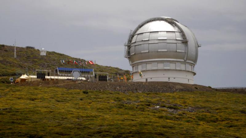 In this July 24, 2009, file photo, the Gran Telescopio Canarias, one of the the world's largest telescopes, is viewed at the Observatorio del Roque de los Muchachos on the Canary Island of La Palma, Spain. An agreement has been reached for a giant telescope to be built in Spain's Canary Islands if it cannot be put atop a Hawaii mountain. Telescope builder TMT International Observatory says Hawaii's Mauna Kea remains the preferred location for the $1.4 billion Thirty Meter Telescope. (AP Photo/Carlos Moreno, File) In this July 24, 2009, file photo, the Gran Telescopio Canarias, one of the the world's largest telescopes, is viewed at the Observatorio del Roque de los Muchachos on the Canary Island of La Palma, Spain. An agreement has been reached for a giant telescope to be built in Spain's Canary Islands if it cannot be put atop a Hawaii mountain. Telescope builder TMT International Observatory says Hawaii's Mauna Kea remains the preferred location for the $1.4 billion Thirty Meter Telescope. (AP Photo/Carlos Moreno, File)