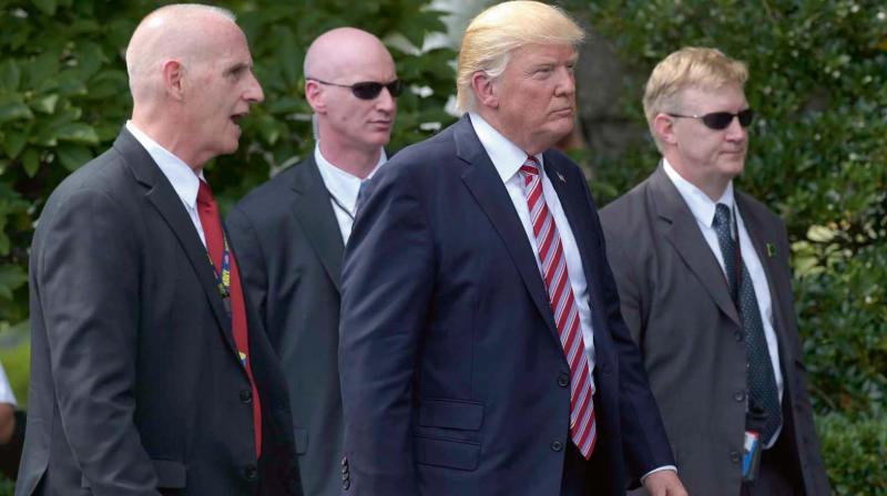 President Donald Trump, his longtime bodyguard Keith Schiller, left, and two secret service agents at the White House in Washington — AP President Donald Trump, his longtime bodyguard Keith Schiller, left, and two secret service agents at the White House in Washington — AP
