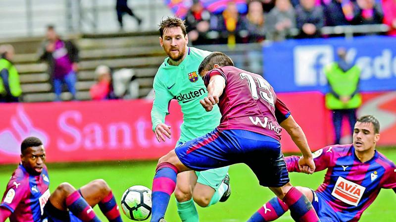 In this file picture, Lionel Messi of Barcelona vies for the ball with players from Eibar during their Spanish league match at the Ipurua stadium in Eibar, northern Spain. In this file picture, Lionel Messi of Barcelona vies for the ball with players from Eibar during their Spanish league match at the Ipurua stadium in Eibar, northern Spain.