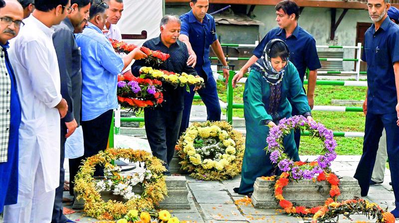 PDP chief Mehbooba Mufti offers floral tribute to the martyrs of 1931, who were killed by the Dogra police, at Ziyarat Naqshband Sahab in Srinagar. (Photo: PTI) PDP chief Mehbooba Mufti offers floral tribute to the martyrs of 1931, who were killed by the Dogra police, at Ziyarat Naqshband Sahab in Srinagar. (Photo: PTI)