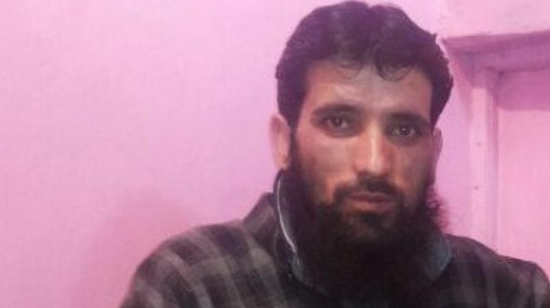The Jammu & Kashmir Police on Friday detained Hizbul Mujahideen terrorist Gulzar Dar in Pulwama district's Tral. (Photo: ANI) The Jammu & Kashmir Police on Friday detained Hizbul Mujahideen terrorist Gulzar Dar in Pulwama district's Tral. (Photo: ANI)