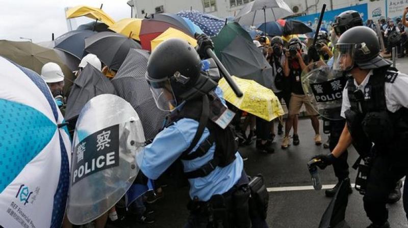 Clashes broke out between Hong Kong Police and anti-government demonstrators on Monday morning ahead of what is expected to be a massive pro-democracy rally on the 22nd anniversary of city's handover from British rule to China. (Photo: ANI) Clashes broke out between Hong Kong Police and anti-government demonstrators on Monday morning ahead of what is expected to be a massive pro-democracy rally on the 22nd anniversary of city's handover from British rule to China. (Photo: ANI)