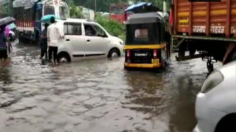 The downpour also led to severe waterlogging in Mumbai and Thane, with locals wading through ankle-deep waters to commute. (Photo: ANI) The downpour also led to severe waterlogging in Mumbai and Thane, with locals wading through ankle-deep waters to commute. (Photo: ANI)