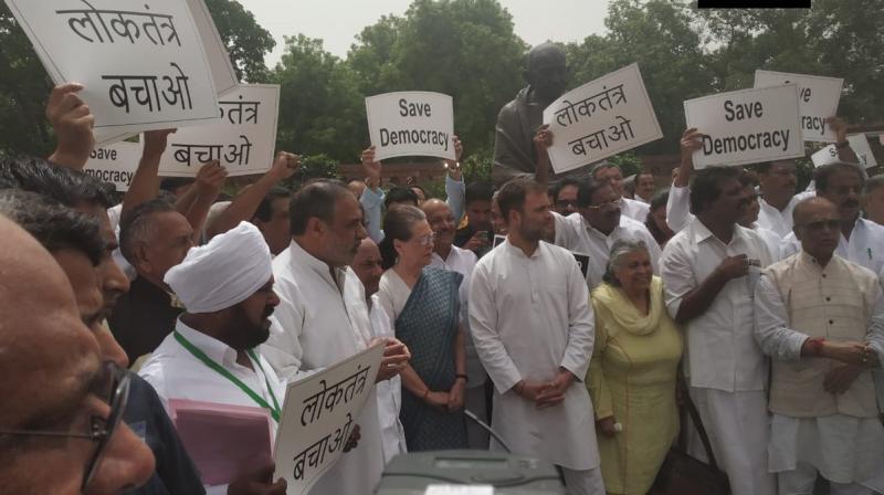 A number of top Congress leaders, including Sonia Gandhi, Rahul Gandhi and Anand Sharma, protested near the Gandhi statue in the Parliament complex and shouted slogans. (Photo: Twitter/ ANI) A number of top Congress leaders, including Sonia Gandhi, Rahul Gandhi and Anand Sharma, protested near the Gandhi statue in the Parliament complex and shouted slogans. (Photo: Twitter/ ANI)