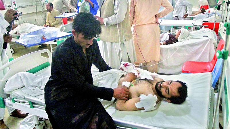 A wounded man receives treatment after the suicide attack in Kabul. — AP A wounded man receives treatment after the suicide attack in Kabul. — AP