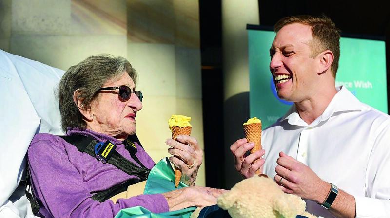 This handout photo taken in Brisbane on Friday shows 92-year-old Betty Dowsett enjoying an ice cream with Queensland Minister for health and ambulance services Steven Miles as she takes the chance to leave palliative care for a few hours to enjoy the sunshine. This handout photo taken in Brisbane on Friday shows 92-year-old Betty Dowsett enjoying an ice cream with Queensland Minister for health and ambulance services Steven Miles as she takes the chance to leave palliative care for a few hours to enjoy the sunshine.