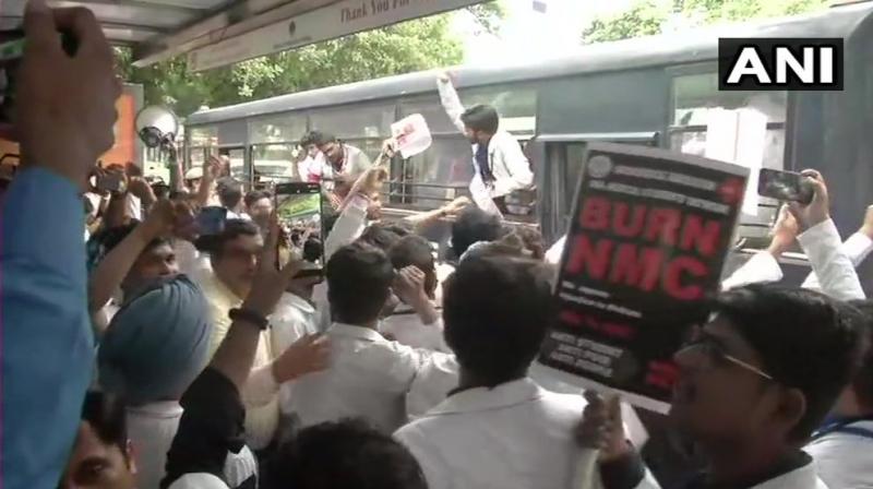 Over 5000 doctors, medical students and healthcare professionals from across the country staged a protest against the National Commission (NMC) Bill 2019 following a call given by IMA, with a march being held from AIIMS to Nirman Bhawan here. (Photo: Twitter/ ANI) Over 5000 doctors, medical students and healthcare professionals from across the country staged a protest against the National Commission (NMC) Bill 2019 following a call given by IMA, with a march being held from AIIMS to Nirman Bhawan here. (Photo: Twitter/ ANI)