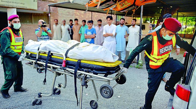 Pakistani rescue workers load a dead body of plane crash victim into an ambulance at a hospital in Rawalpindi, Pakistan, on Tuesday. — AP Pakistani rescue workers load a dead body of plane crash victim into an ambulance at a hospital in Rawalpindi, Pakistan, on Tuesday. — AP