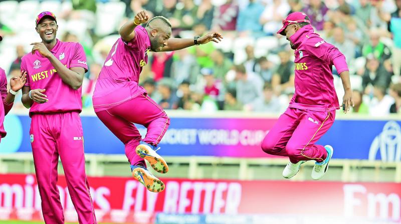 Andre Russell (centre) and Darren Bravo celebrate a Pakistan wicket as skipper Jason Holder (left) looks on during their World Cup match at Nottingham on Friday. (Photo: AP) Andre Russell (centre) and Darren Bravo celebrate a Pakistan wicket as skipper Jason Holder (left) looks on during their World Cup match at Nottingham on Friday. (Photo: AP)