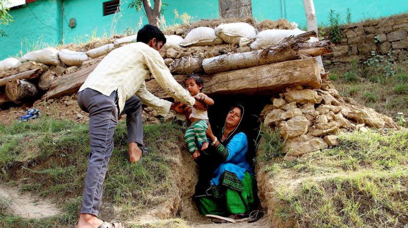 Border migrants take shelter in a bunker after shelling from Pakistan side at Nowshera sector of Rajouri district. (Photo: PTI) Border migrants take shelter in a bunker after shelling from Pakistan side at Nowshera sector of Rajouri district. (Photo: PTI)