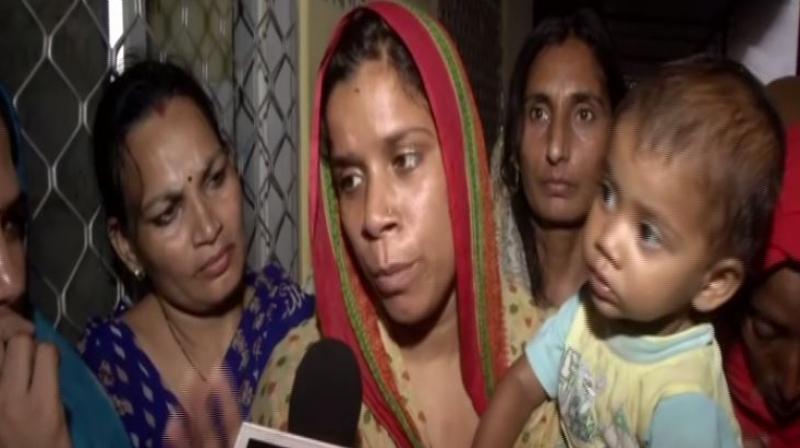 They are agitating with the body of Rekha's father-in-law who the family says consumed poison due to police apathy in the case of his son's death. (Photo: ANI) They are agitating with the body of Rekha's father-in-law who the family says consumed poison due to police apathy in the case of his son's death. (Photo: ANI)